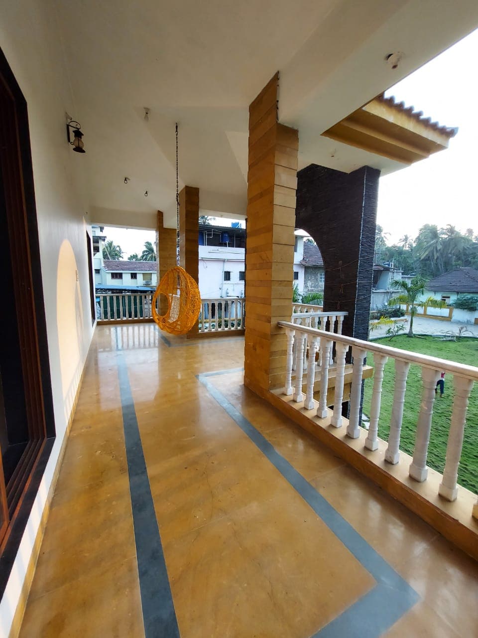 The upstairs balcony with a hanging swing chair